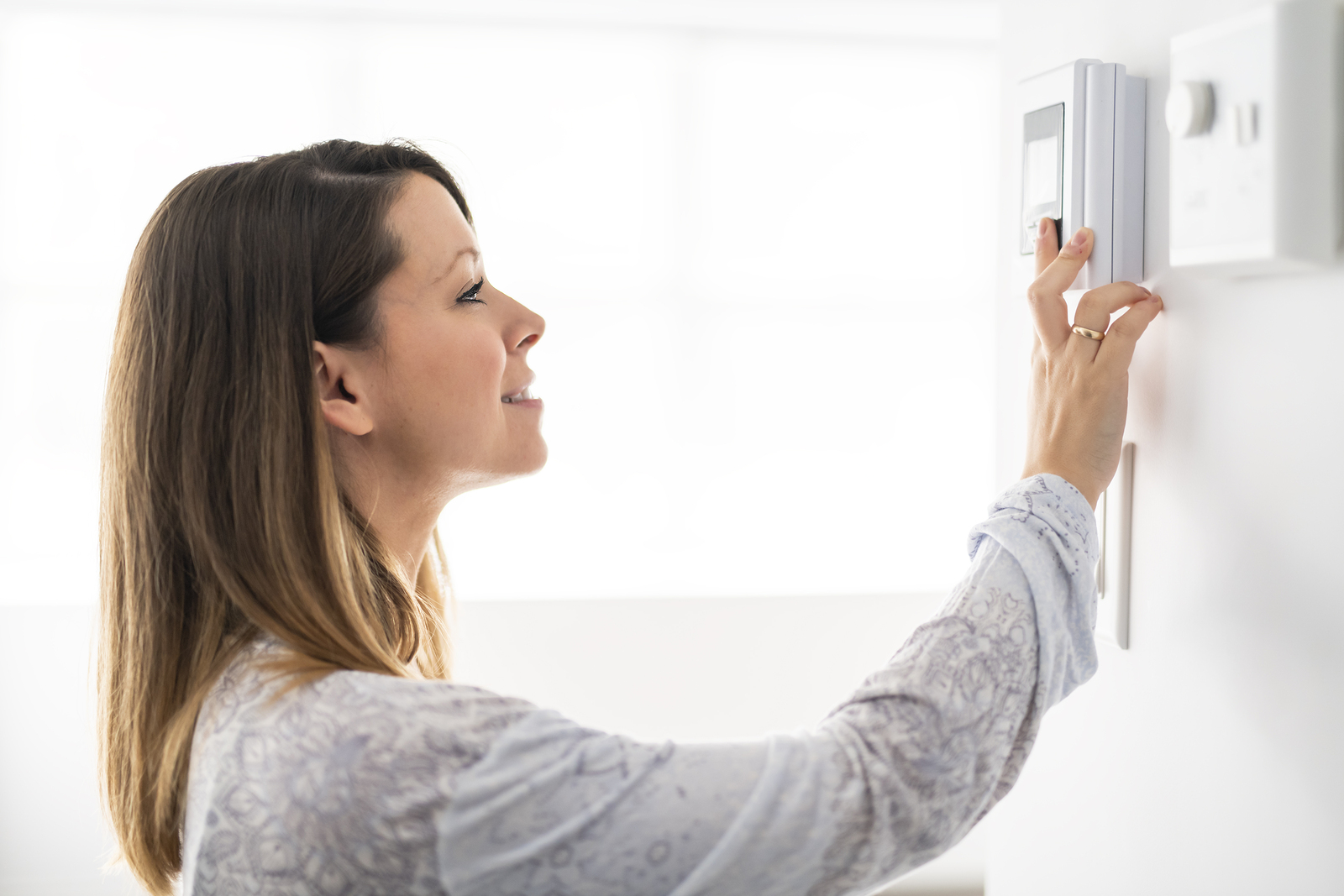 bigstock A Woman Set The Thermostat